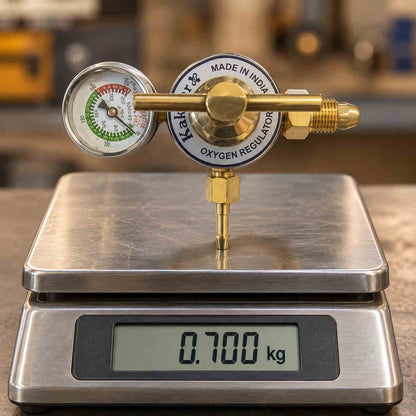 A brass oxygen regulator with a round analog pressure gauge, adjustment knob, and threaded connector, shown on a plain white background. The gauge has a white face with red, green, and black markings, and the main body is brass with a blue and white circular label reading 'K&H OXYGEN REGULATOR' and 'MADE IN INDIA'.