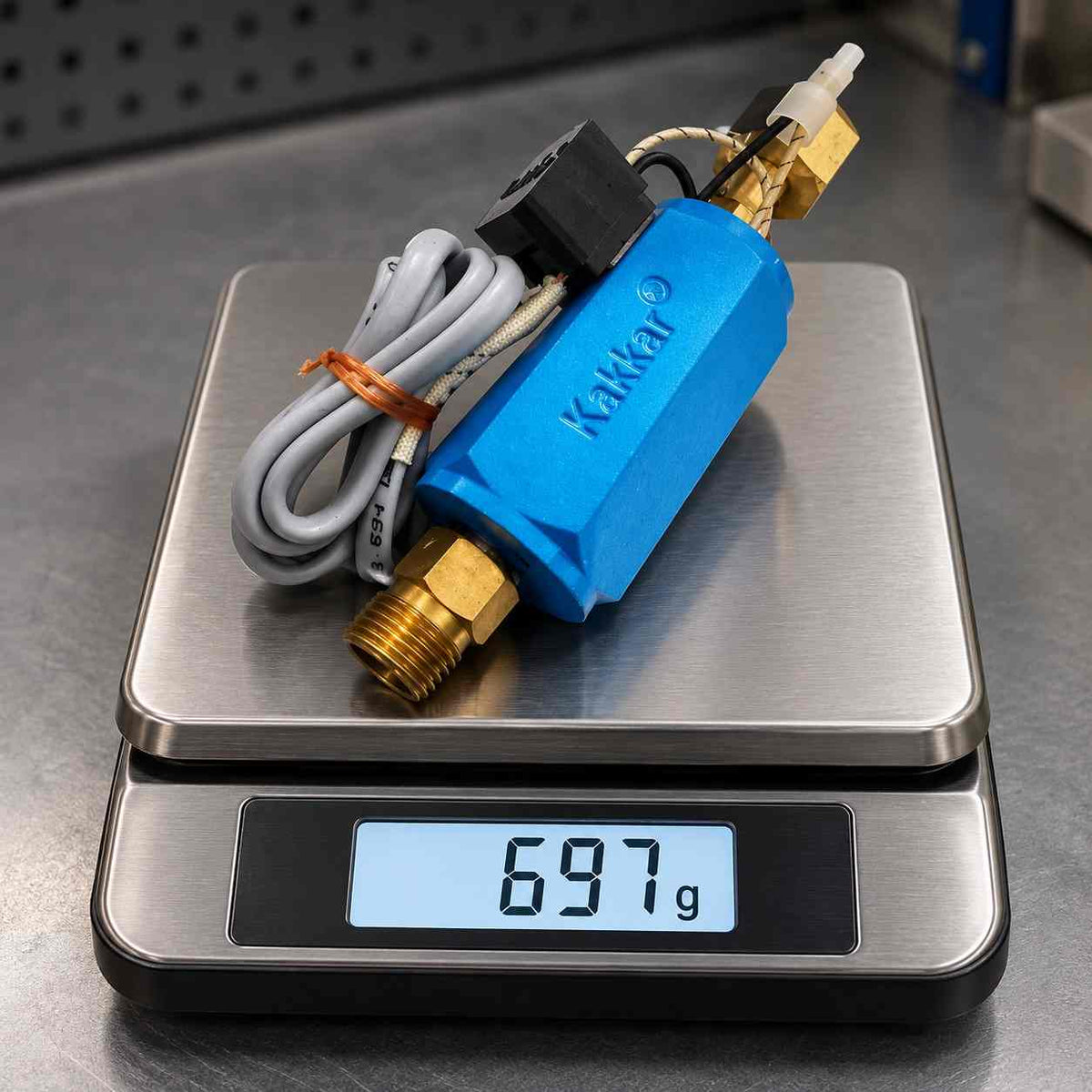 A blue and brass gas burner regulator with a gray power cord and a black switch, shown on a white background.